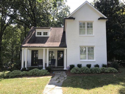 Tucker's Home Services — AFTER photo of the same Woodstock home with freshly painted trim and new dark shutters after exterior refresh