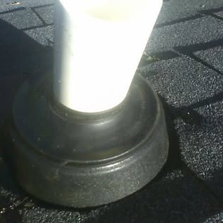 Tucker's Home Services — rubber boot flashing around a plumbing vent pipe on an asphalt shingle roof after repair